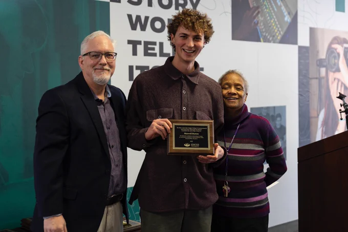Journalism major Maxwell Burton, center, with Dean Scott Titsworth, left, and journalism school director Dr. Eddith Dashiell, right
