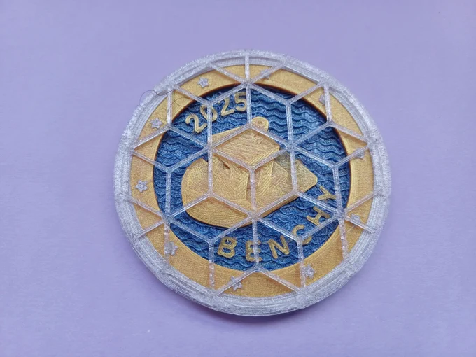 The Benchy coin, with a rhombille pattern cover to use the coin as a coaster.