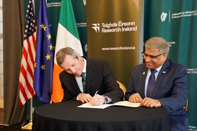 Ciarán Seoighe and Sethuraman Panchanathan sitting at a table signing the new partnership agreement