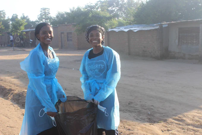 Ancia (left) a tutor at community-based TWEENS and Kereni (right), RCCA members participating in Clean-up Campaign at Tongogara Refugee Camp.
