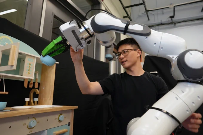 Person working on a robotic arm.