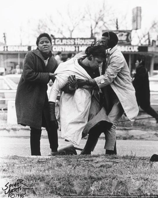 A black-and-white photograph of Amelia Boynton Robinson, who is weak from being attacked and gassed by Alabama State Troopers.
