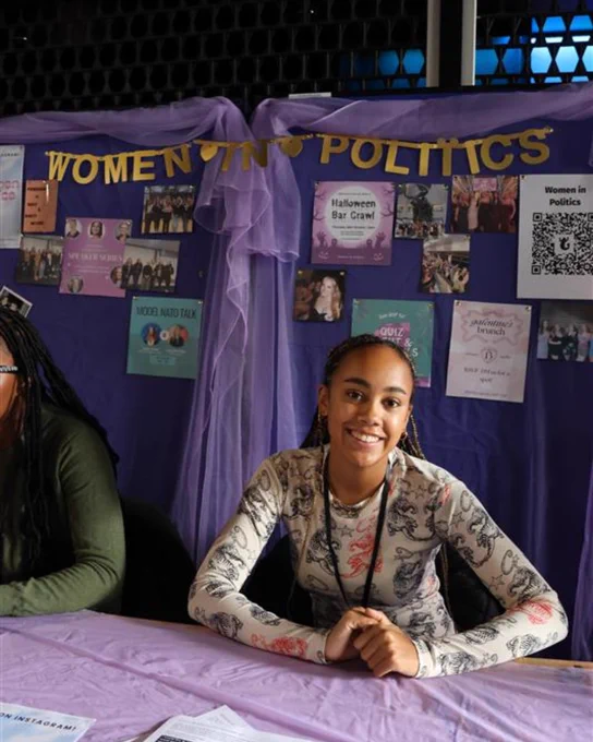 Image of a student smiling at the camera from the society 'Women in Politics'.