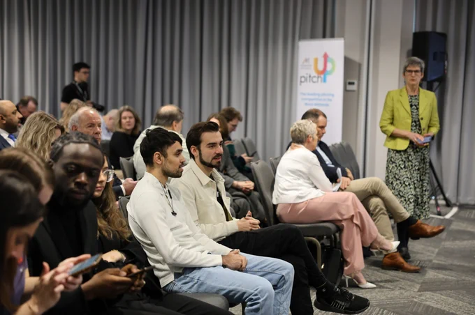 A crowd of attendees sit down and discuss at Venturefest West Midlands 2024