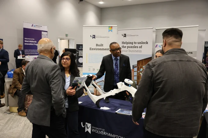 An exhibitor demonstrates a technological device at Venturefest West Midlands 2024 