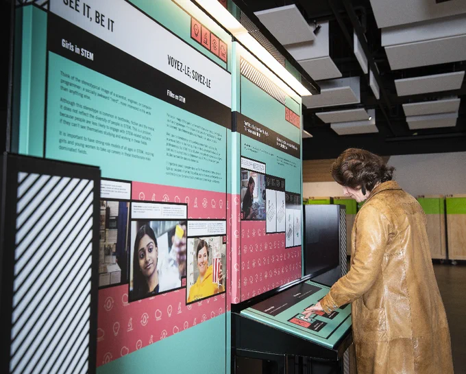 IMAGE: Photo of a person standing up interacting with the "Iron Willed: Women in STEM" exhibition, presented by Ingenium and NSERC. 