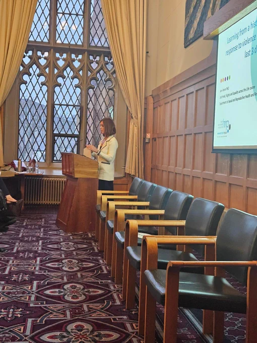 Dr Jenny McNeill welcoming guest in Canada Room QUB