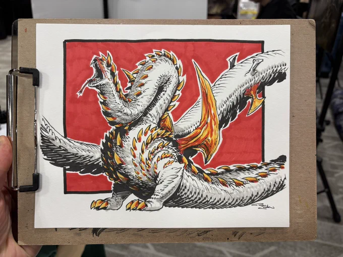 Photo of an ink and marker sketch. A spikey snake-like monster with two legs stretches upward with its mouth open and snake tongue out.