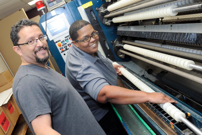 Rick and Tiffany are working on the tape machine in the Alphapointe Office Products department. 