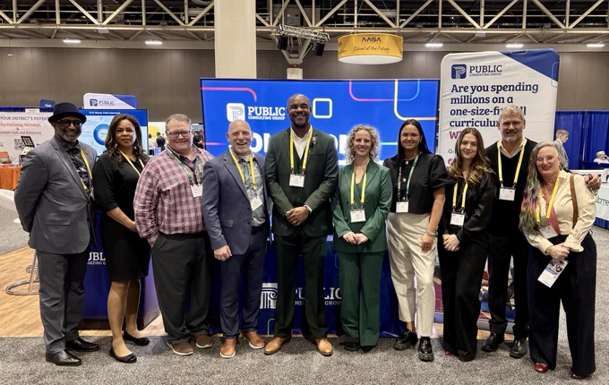 Group of people standing in front of conference booth