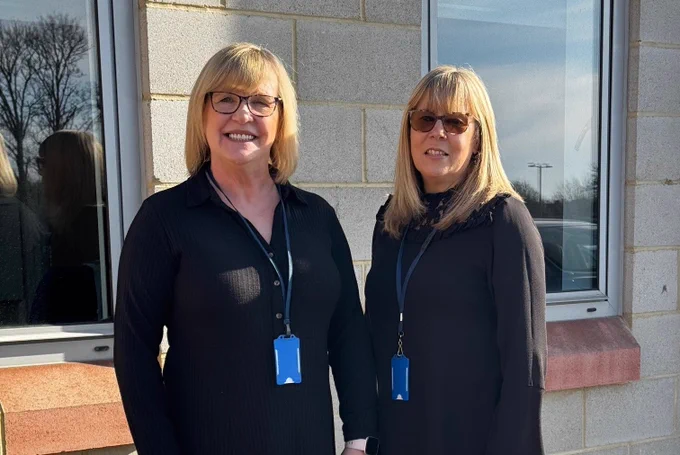 Lisa and Celia standing outside in front of a building