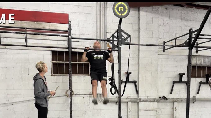 Me completing a pull up with my chin over the bar
