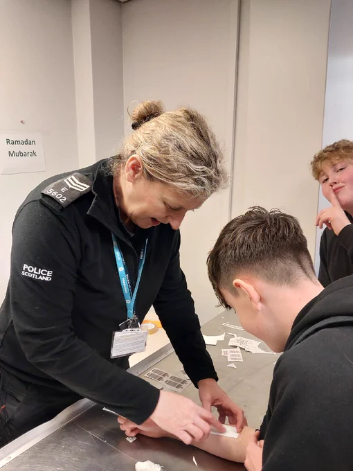 A police Sergeant interacts with a pupil