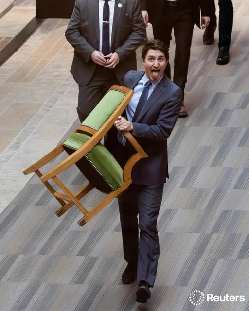 Canada's Prime Minister Justin Trudeau carries his chair from the House of Commons on Parliament Hill in Ottawa, Canada