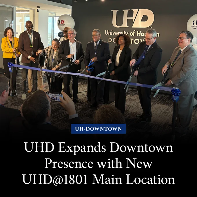 People cutting a large ribbon with large scissors with text that says, “UHD Expands Downtown Presence with New UHD@1801 Main Location.“
