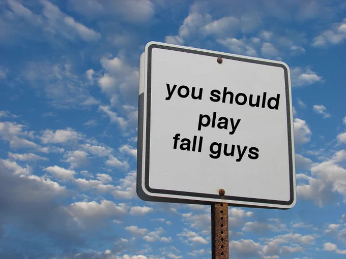 A road sign says "you should play fall guys".