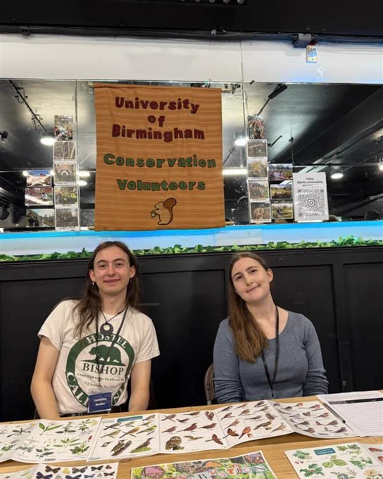 Image of two students smiling at the camera who are a part of the Conservation Volunteers.