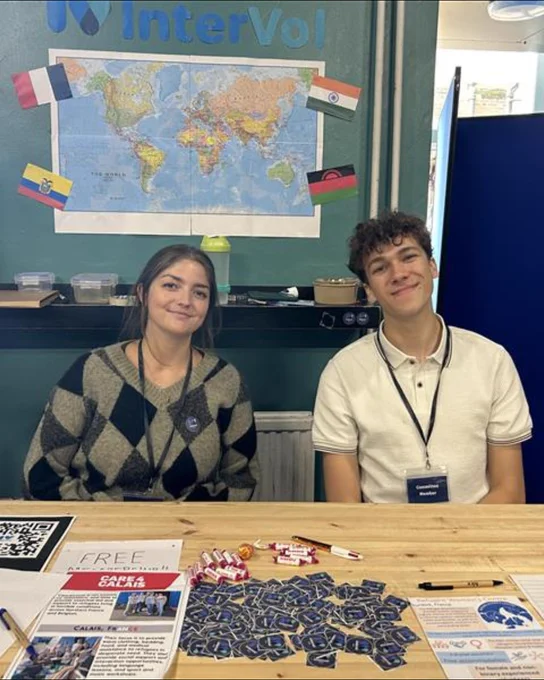 Image of two students smiling at the camera who are a part of InterVol.