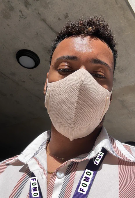 selfie of a cutie pie guy (me) in a cream colored AusAir KN95 mask, a collared shirt and natural lighting