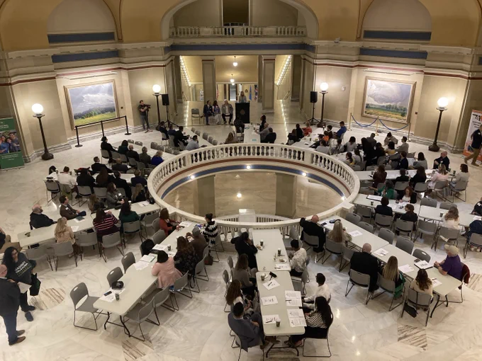 Large group of people congregate in the rotunda of the Oklahoma State Capitol building