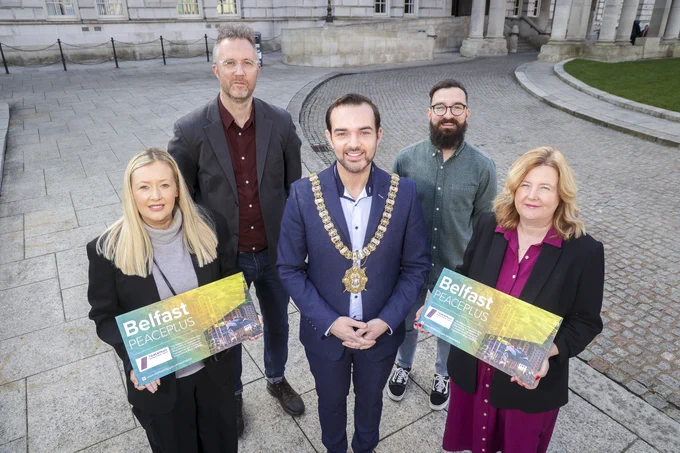 Lord Mayor and representatives of some of the delivery partners appointed to deliver Belfast PEACEPLUS projects in front of City Hall