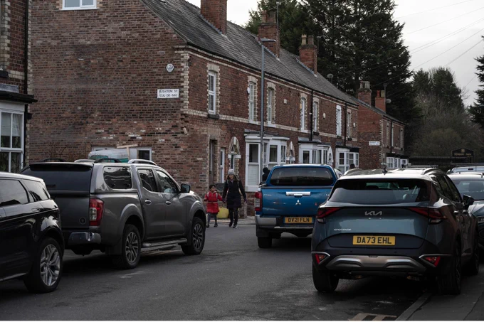 Liz Godfrey walks her children to school through busy traffic, on 24th January 2024 in Didsbury, Manchester, England. 

Credit: Mary Turner / Climate Visuals