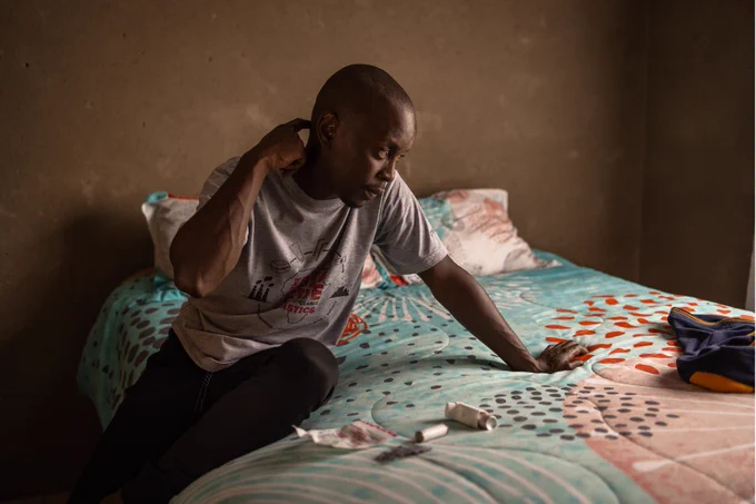 Lifa Mnisi (29) explains his medication in his home in the Vosman area in Witbank, Emalahleni, South Africa, on November 29, 2023. Lifa was diagnosed with bronchitis and asthma in 2007 after many trips to the doctor and misdiagnoses.

Credit: Gulshan Khan / Climate Visuals