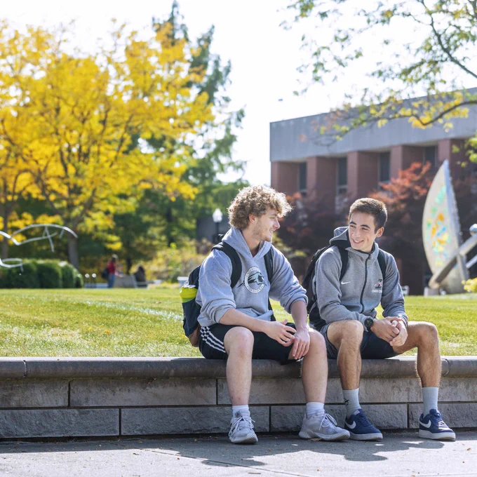 Students talking outside the library in Spring weather