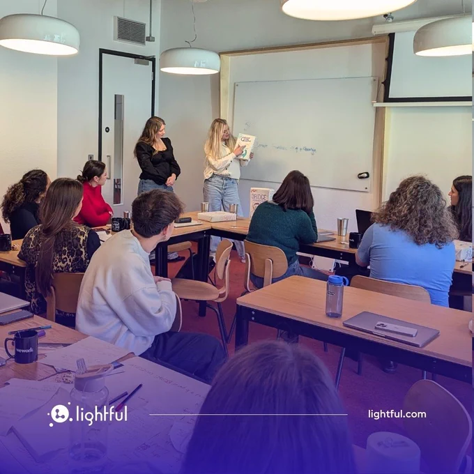 Georgie and Jamie presenting to a room of Lightful team members
