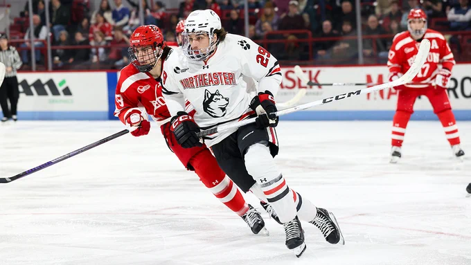 Cristophe Tellier skating in a white Northeastern jersey