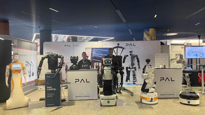 PAL Robotics stand at the European Robotics Forum 2025 (ERF) in Stuttgart. From left to right: the AI social robot ARI, the new dynamic biped platform Kangaroo with new arms, the last generation mobile manipulator TIAGo Pro, the customisable and reliable mobile manipulator TIAGo, and the autonomous mobile base for research, TIAGo Base AI.