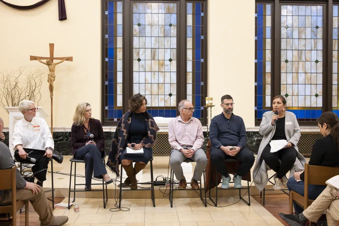 4 women and 2 men sitting before an audience in a church.