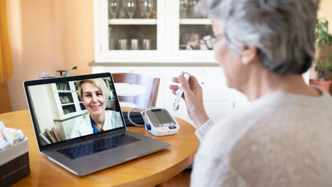 Older woman having a telehealth visit with a health care provider