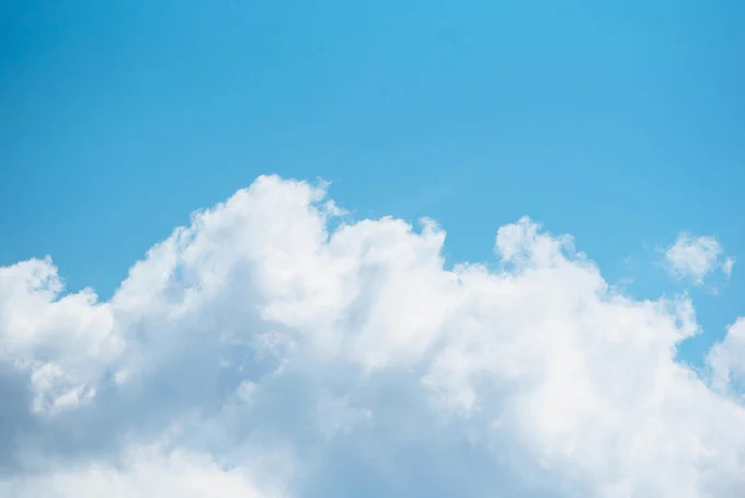 Blue sky with clouds. Photo by CHUTTERSNAP on Unsplash