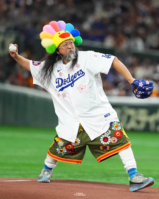 Takashi Murakami prepares to throw a pitch while wearing a limited edition Tokyo Series Dodgers jersey.
