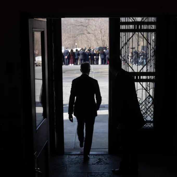 Prime Minister Mark Carney walks outside towards reporters at Rideau Hall.
