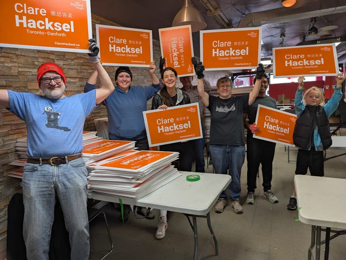A group of volunteers holding "Clare Hacksel" election signs