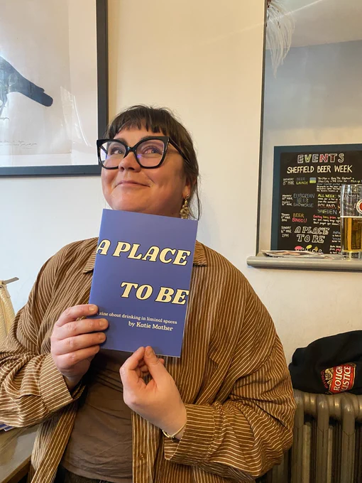 Katie holding A Place To Be ‘zine