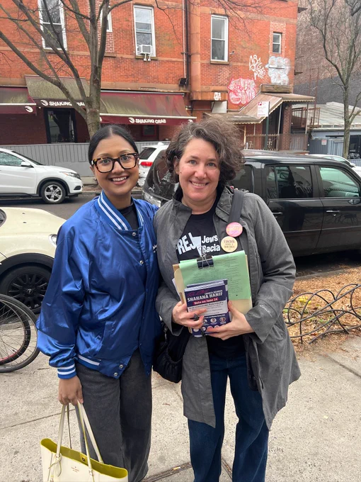 Photo of Shahana Hanif with a JFREJ member holding a petitioning clipboard.