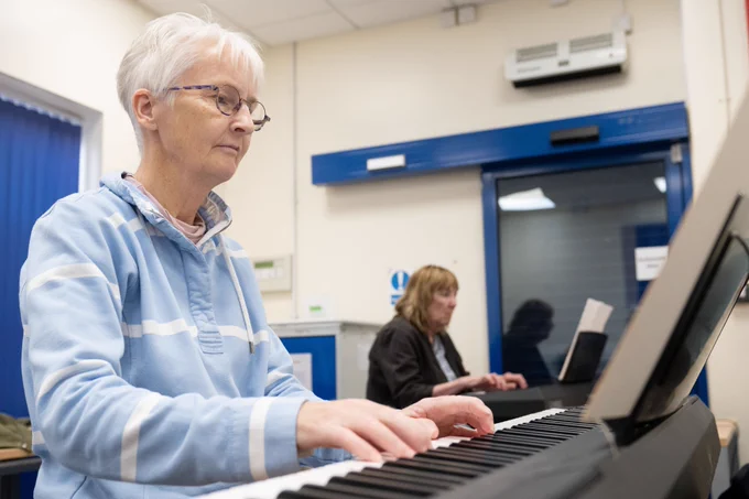 A lady playing a piano. 