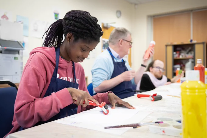 Three people taking part in an art course.