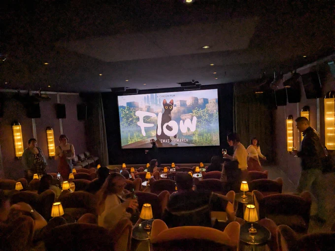 A photograph of a cinema screen showing the title card for the Oscar winning animated movie Flow
