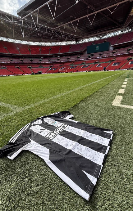 A signed Newcastle United shirt is laid out on the Wembley pitch ahead of the Carabao Cup Final.