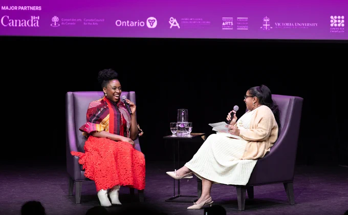 Author Chimamanda Ngozi Adichie speaks with a host on stage at the Isabel Bader Theatre.