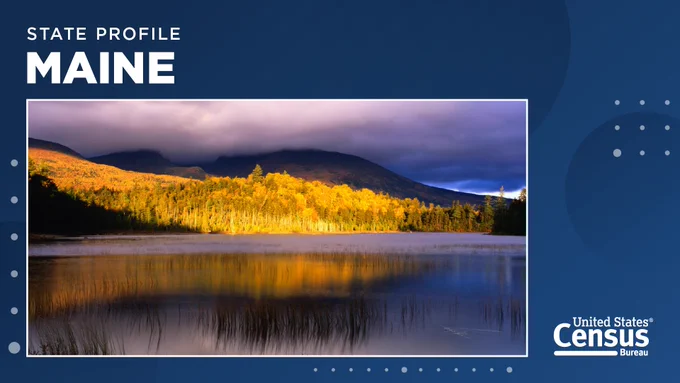 a lake overlooking mountains and trees in the distance