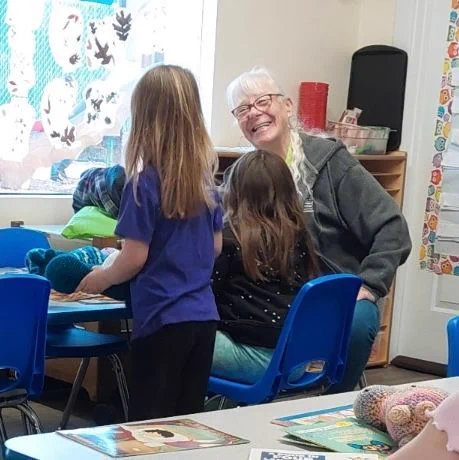 Nadine Devaney with Winston UCAN Head Start students and a big smile.