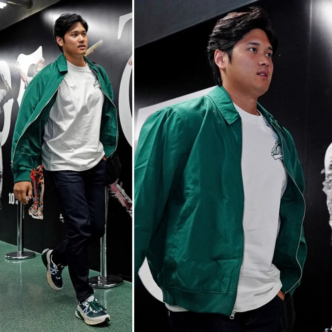 Two photos of Shohei Ohtani walking into the Tokyo Dome. He's wearing a green jacket, white shirt, black pants, and green and white shoes.