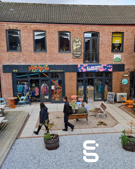 An image of The Cooperage, several businesses are housed in a red brick building.