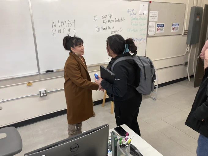Leah Gazan shaking hands with a student after the presentation
