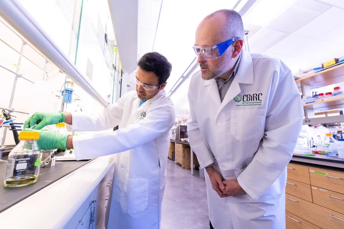 Jean-Philippe Tessonnier, right, and Prathamesh Prabhu, a doctoral student, work to combine electro- and bio- reactions to create the building blocks of common nylons and plastics. Photo by Christopher Gannon.